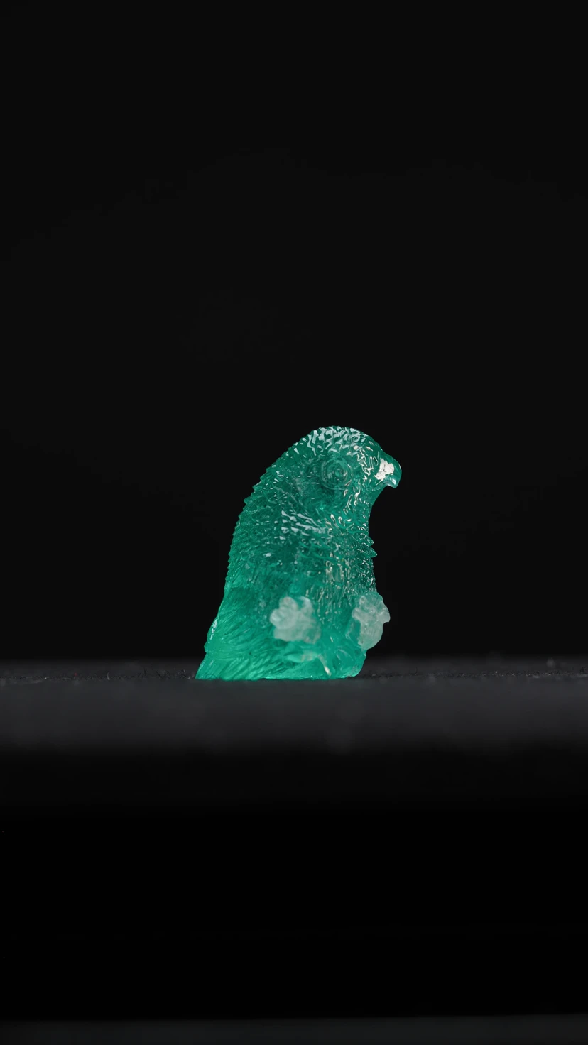 The founder studying a blue rough gemstone in profile